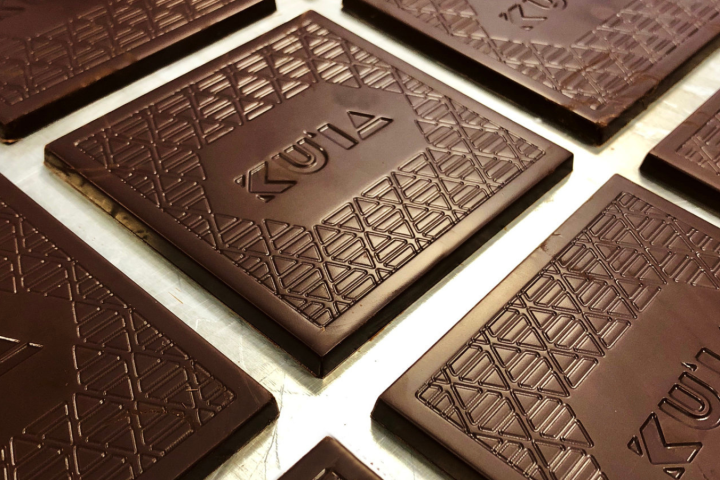 a clock sitting in front of a laptop