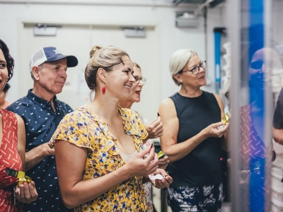 a group of people looking at a cell phone