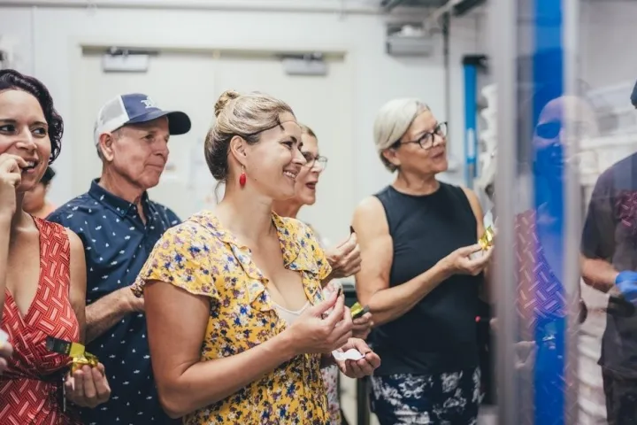a group of people looking at a cell phone
